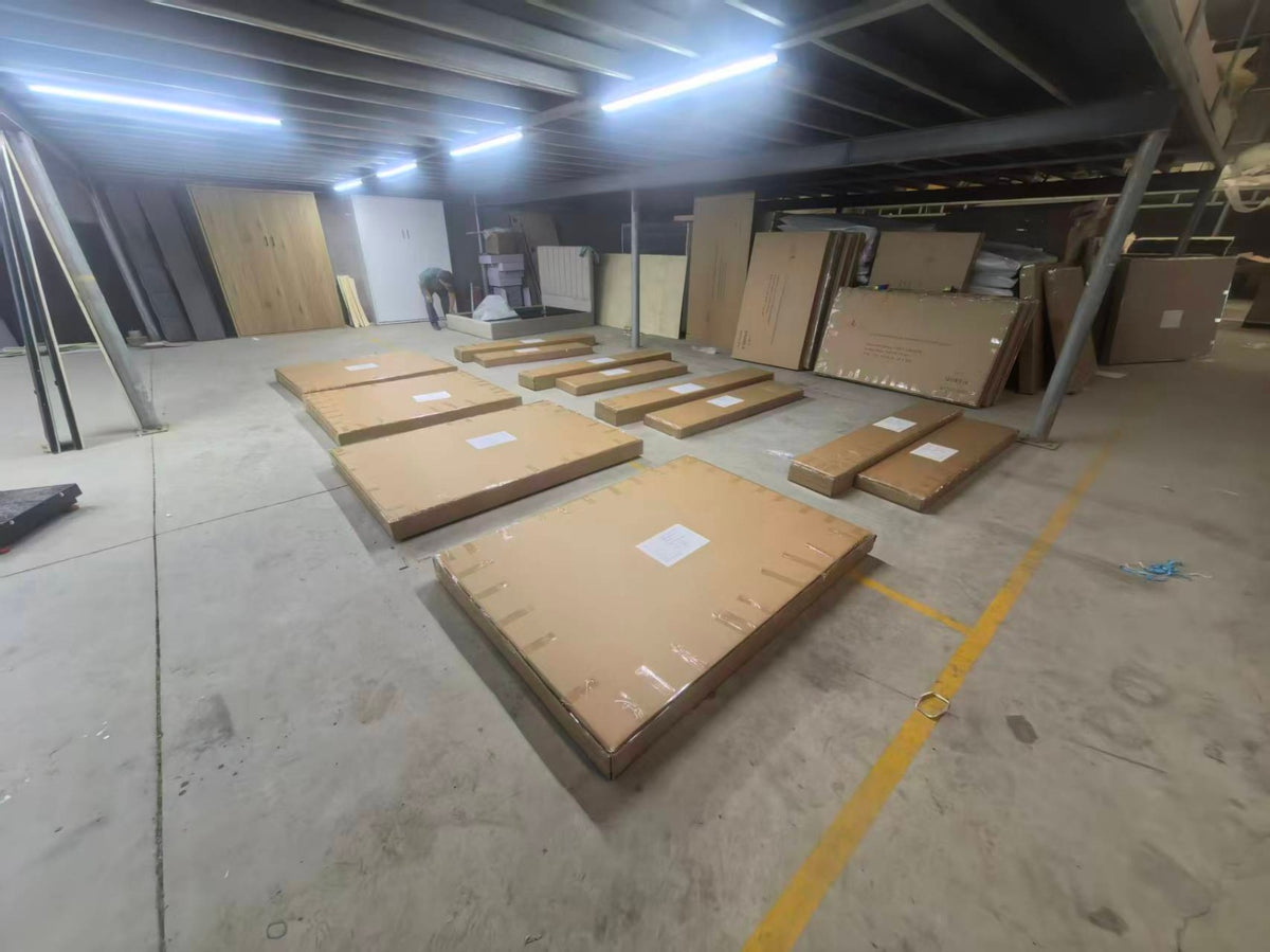 Five flat-packed cartons laid out for inspection — headboard, footboard, side rails and slats